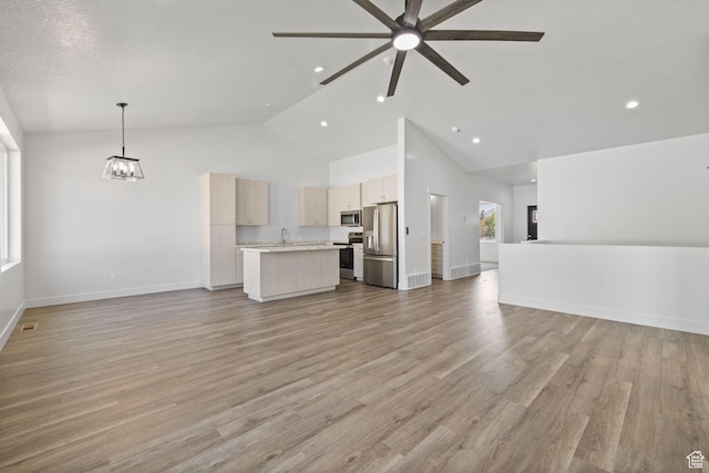 387 N 300 E, Payson, UT 84651 - unfurnished living room with a ceiling fan, high vaulted ceiling, recessed lighting, light wood-style floors, and a chandelier