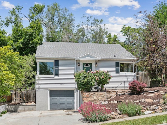 1143 E Sunnyside Ave S, Salt Lake City, UT 84102 - view of front facade featuring an attached garage, driveway, and roof with shingles