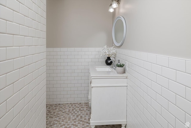 1697 S 3200 W, Logan, UT 84321 - bathroom with tile walls, vanity, wainscoting, and tile patterned floors