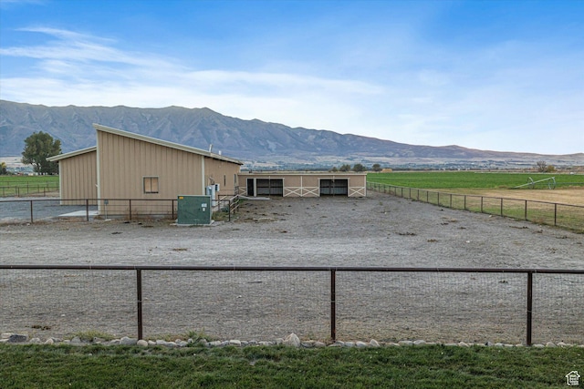 1697 S 3200 W, Logan, UT 84321 - view of side of property featuring a mountain view, an exterior structure, and a view of countryside