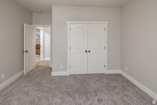 1697 S 3200 W, Logan, UT 84321 - unfurnished bedroom with carpet floors, a closet, and baseboards
