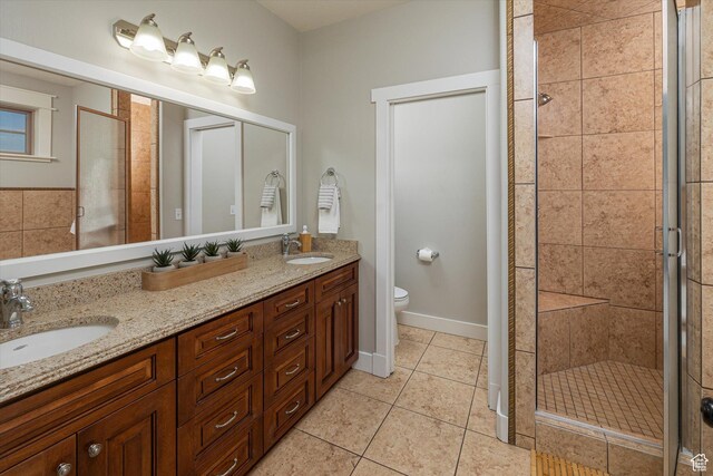 1697 S 3200 W, Logan, UT 84321 - full bath with double vanity, a stall shower, toilet, and tile patterned floors