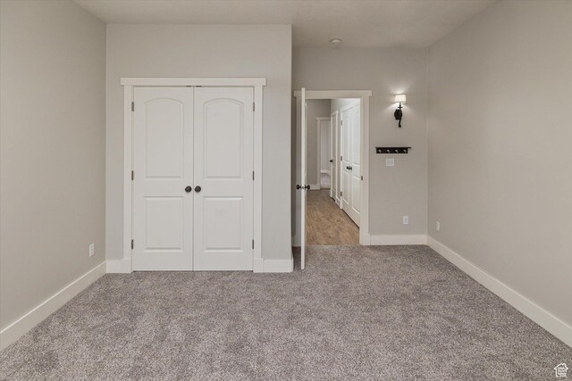 1697 S 3200 W, Logan, UT 84321 - unfurnished bedroom with carpet flooring, a closet, and baseboards