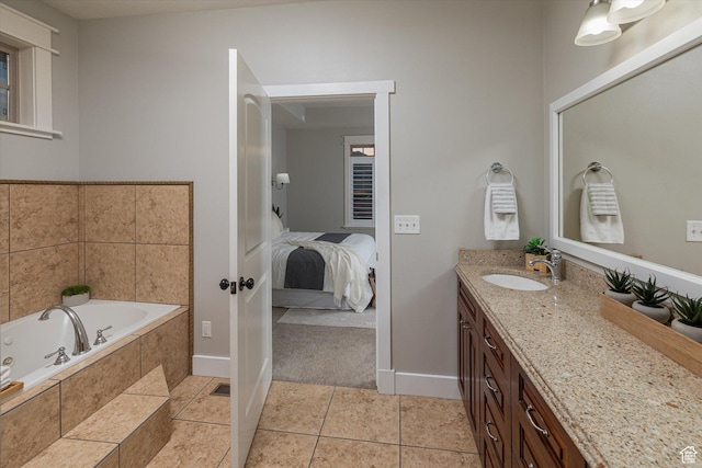 1697 S 3200 W, Logan, UT 84321 - bathroom featuring vanity, a jetted tub, tile patterned flooring, baseboards, and ensuite bath