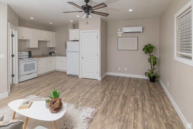 1697 S 3200 W, Logan, UT 84321 - kitchen featuring white appliances, a wall unit AC, light wood-type flooring, a ceiling fan, and recessed lighting
