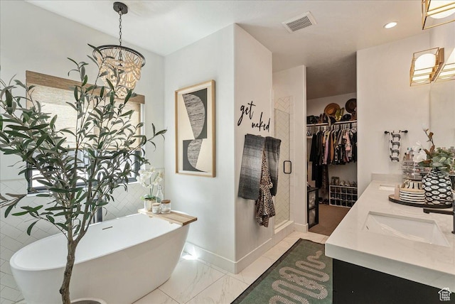 144 E 150 N, Vineyard, UT 84059 - full bathroom featuring a soaking tub, double vanity, a chandelier, a walk in closet, and marble finish flooring