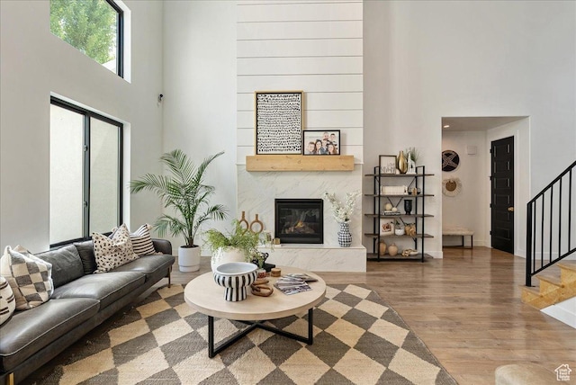 144 E 150 N, Vineyard, UT 84059 - living area with a towering ceiling, stairs, wood finished floors, a fireplace, and baseboards