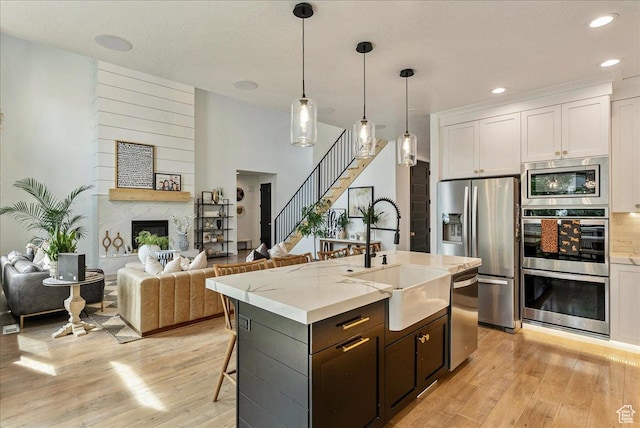 144 E 150 N, Vineyard, UT 84059 - kitchen featuring a sink, stainless steel appliances, light wood-type flooring, white cabinetry, and recessed lighting