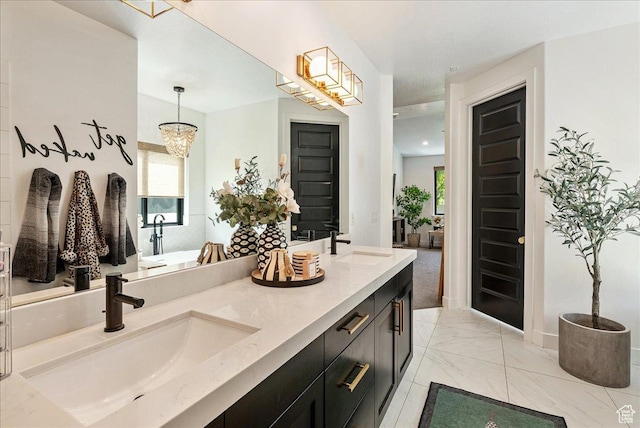 144 E 150 N, Vineyard, UT 84059 - bathroom with marble look tile flooring, double vanity, healthy amount of natural light, and a chandelier