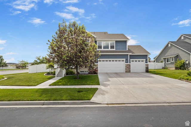 541 N Trek Rd, Saratoga Springs, UT 84045 - view of front of home featuring stone siding, driveway, and an attached garage