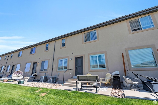 187 E 560 N, Salem, UT 84653 - back of property featuring cooling unit, a patio area, stucco siding, and a lawn