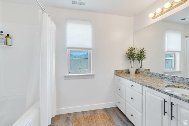 187 E 560 N, Salem, UT 84653 - bathroom with vanity, wood finished floors, shower / bathtub combination with curtain, and baseboards