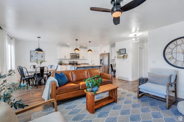 187 E 560 N, Salem, UT 84653 - living area with wood finished floors, a ceiling fan, and baseboards