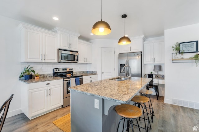 187 E 560 N, Salem, UT 84653 - kitchen with appliances with stainless steel finishes, a sink, baseboards, white cabinetry, and recessed lighting