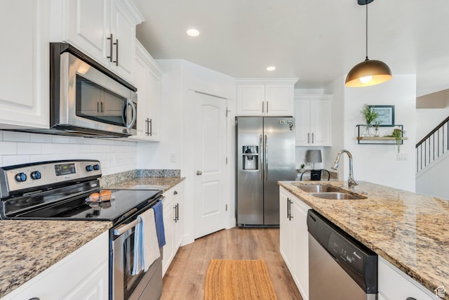 187 E 560 N, Salem, UT 84653 - kitchen with stainless steel appliances, light wood-style floors, white cabinets, a sink, and recessed lighting