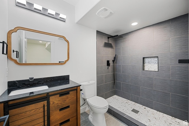 12719 S Outlaw Pl E, Draper, UT 84020 - bathroom with vanity, toilet, a tile shower, and tile patterned floors