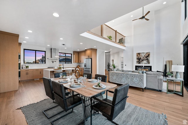 12719 S Outlaw Pl E, Draper, UT 84020 - dining area featuring light wood-style floors, a ceiling fan, recessed lighting, and a glass covered fireplace