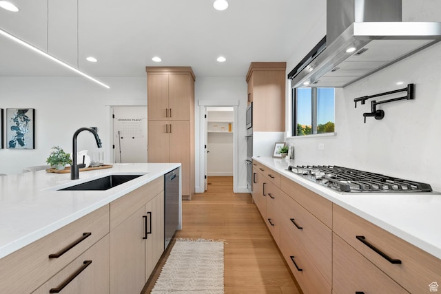 12719 S Outlaw Pl E, Draper, UT 84020 - kitchen with light brown cabinets, appliances with stainless steel finishes, a sink, wall chimney range hood, and light countertops