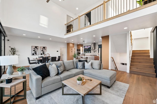 12719 S Outlaw Pl E, Draper, UT 84020 - living room with a high ceiling, light wood-style floors, stairs, and recessed lighting