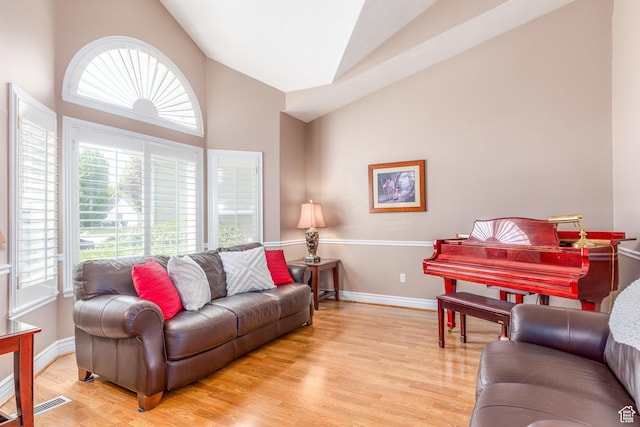497 E Spruce Glen Rd, Murray, UT 84107 - living room with plenty of natural light, light wood-style floors, baseboards, and high vaulted ceiling