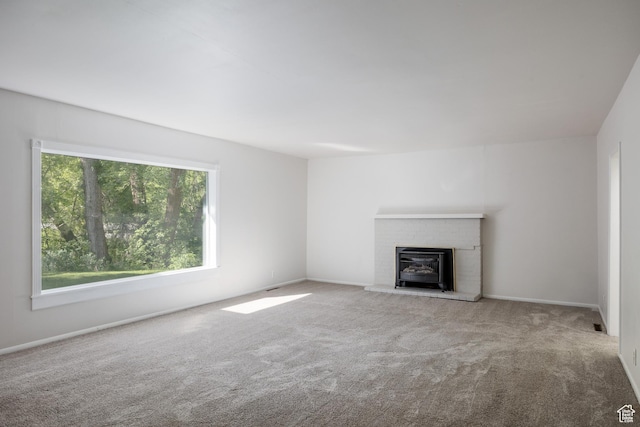 5623 E Emigration Canyon Rd, Emigration Canyon, UT 84108 - unfurnished living room featuring carpet floors, a fireplace, and baseboards