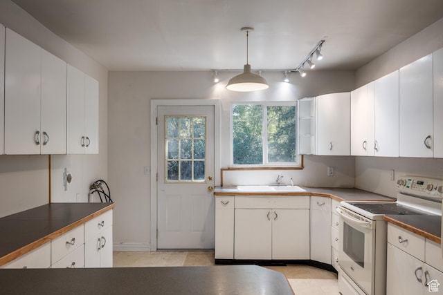 5623 E Emigration Canyon Rd, Emigration Canyon, UT 84108 - kitchen with white electric stove, a sink, white cabinets, and pendant lighting
