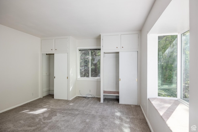 5623 E Emigration Canyon Rd, Emigration Canyon, UT 84108 - unfurnished bedroom featuring two closets, light colored carpet, and baseboards