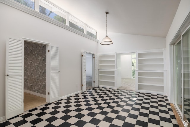 5623 E Emigration Canyon Rd, Emigration Canyon, UT 84108 - unfurnished dining area with a towering ceiling, tile patterned floors, and baseboards