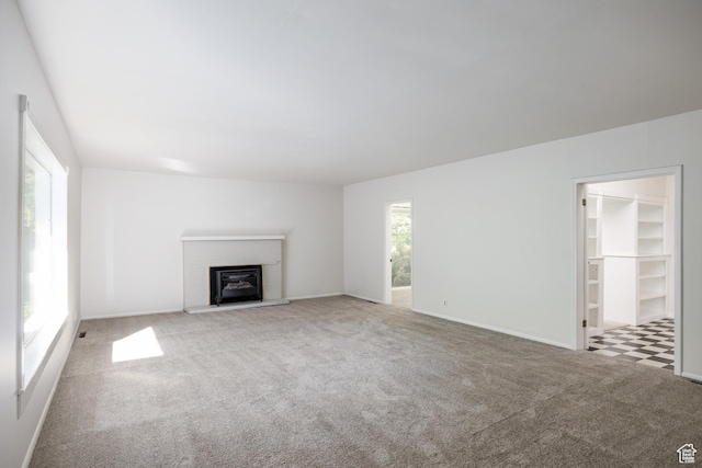 5623 E Emigration Canyon Rd, Emigration Canyon, UT 84108 - unfurnished living room with carpet floors, a glass covered fireplace, and baseboards