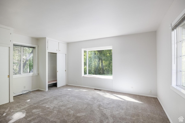 5623 E Emigration Canyon Rd, Emigration Canyon, UT 84108 - unfurnished bedroom featuring multiple windows, carpet floors, and baseboards