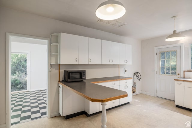 5623 E Emigration Canyon Rd, Emigration Canyon, UT 84108 - kitchen with white cabinets, dark countertops, light flooring, pendant lighting, and baseboards