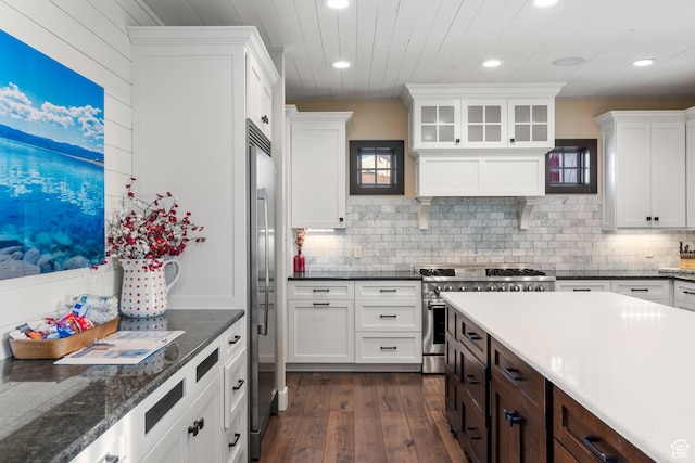 300 S 100th St W, Garden City, UT 84028 - kitchen with premium appliances, recessed lighting, dark wood-type flooring, white cabinets, and backsplash