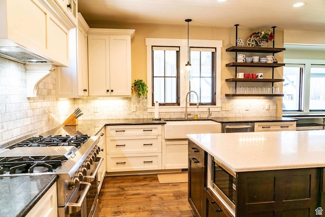 300 S 100th St W, Garden City, UT 84028 - kitchen featuring stainless steel appliances, a sink, dark stone countertops, recessed lighting, and tasteful backsplash