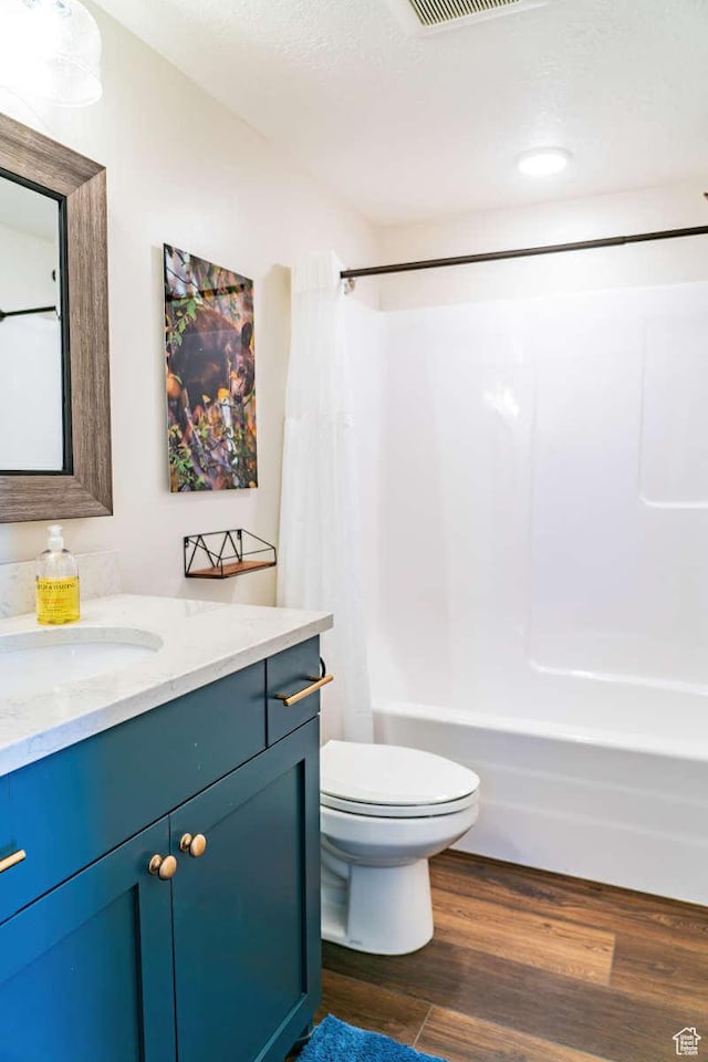300 S 100th St W, Garden City, UT 84028 - full bath featuring vanity, shower / tub combo, toilet, and wood finished floors