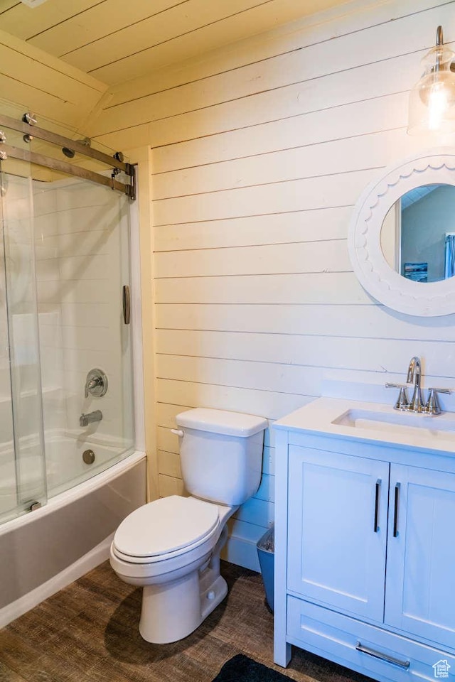 300 S 100th St W, Garden City, UT 84028 - bathroom featuring wood walls, toilet, vanity, and enclosed tub / shower combo