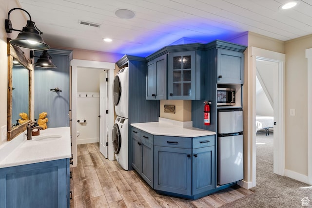 300 S 100th St W, Garden City, UT 84028 - washroom featuring stacked washing machine and dryer, recessed lighting, wooden ceiling, baseboards, and light wood-style flooring