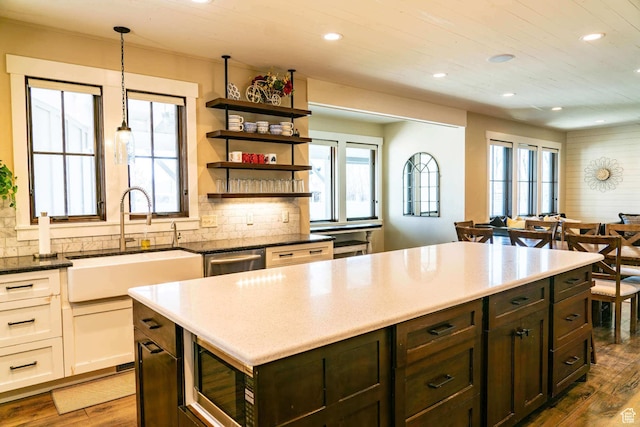 300 S 100th St W, Garden City, UT 84028 - kitchen featuring stainless steel appliances, recessed lighting, dark wood-style floors, a sink, and decorative backsplash