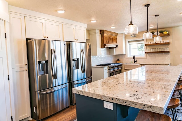 300 S 100th St W, Garden City, UT 84028 - kitchen with stainless steel appliances, a sink, a kitchen bar, open shelves, and dark wood-style flooring