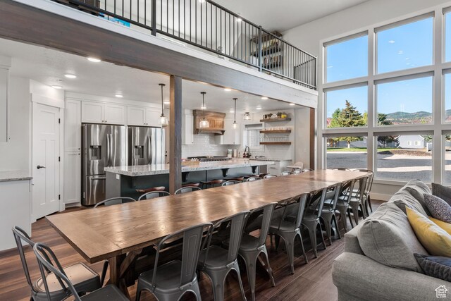 300 S 100th St W, Garden City, UT 84028 - dining space featuring dark wood-style floors, a towering ceiling, and recessed lighting
