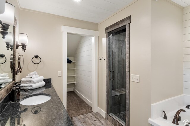 300 S 100th St W, Garden City, UT 84028 - bathroom featuring a shower stall, a bath, wood finished floors, and vanity