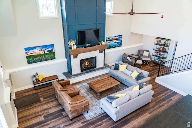 300 S 100th St W, Garden City, UT 84028 - living area with wood finished floors, a fireplace, baseboards, stairs, and a high ceiling