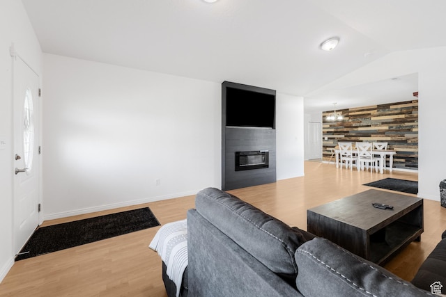 4155 S 3450 W, West Haven, UT 84401 - living room with wood finished floors, lofted ceiling, a fireplace, baseboards, and an accent wall