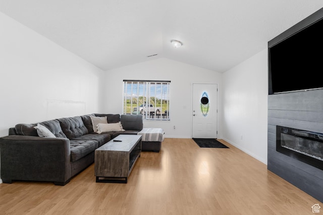 4155 S 3450 W, West Haven, UT 84401 - living room with lofted ceiling, light wood-style flooring, a glass covered fireplace, and baseboards