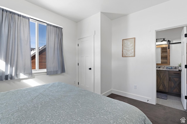 689 N Cambry Dr, Garden City, UT 84028 - bedroom featuring dark carpet, baseboards, and ensuite bathroom