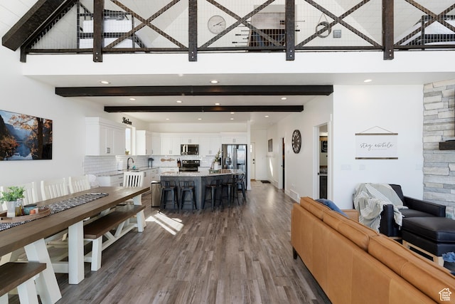 689 N Cambry Dr, Garden City, UT 84028 - living area featuring a towering ceiling, wood finished floors, beam ceiling, and recessed lighting