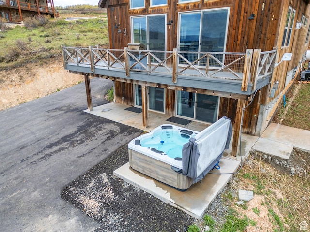 689 N Cambry Dr, Garden City, UT 84028 - back of house with a hot tub, a patio, and a deck