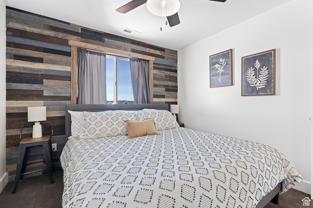 689 N Cambry Dr, Garden City, UT 84028 - carpeted bedroom with wooden walls, an accent wall, and ceiling fan