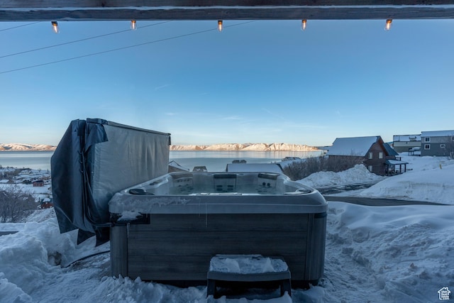 689 N Cambry Dr, Garden City, UT 84028 - snow covered patio featuring a hot tub and a water view