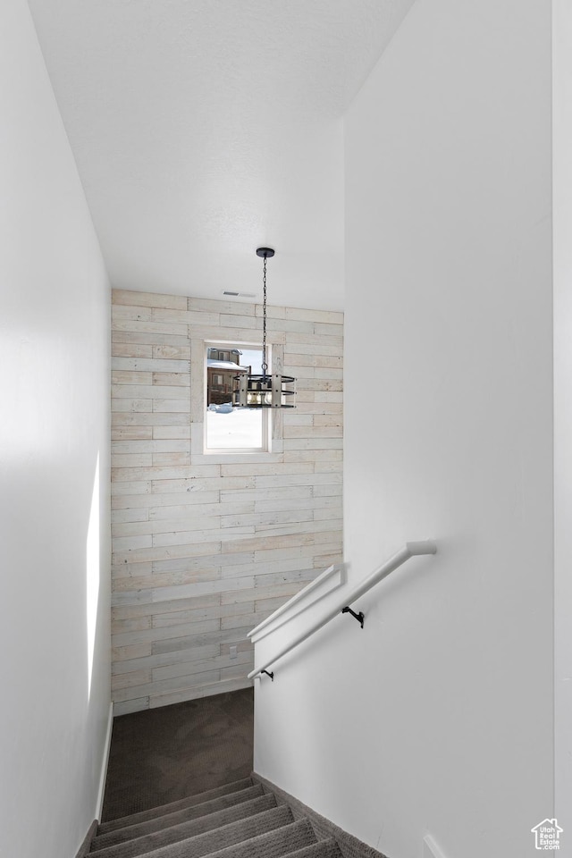 689 N Cambry Dr, Garden City, UT 84028 - staircase featuring carpet floors, baseboards, and a chandelier