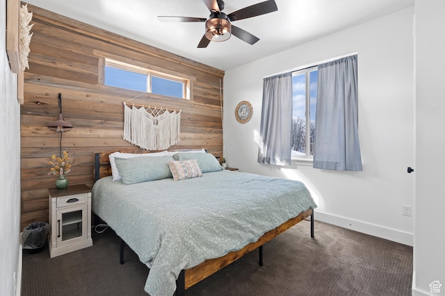 689 N Cambry Dr, Garden City, UT 84028 - carpeted bedroom featuring wooden walls, baseboards, ceiling fan, and an accent wall